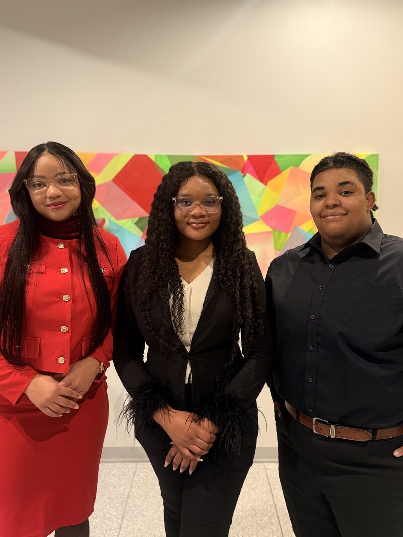 Three Elite Strategies team members dressed in professional business attire